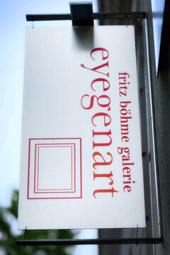 Cologne, Germany July 25 2026: Signboard at the facade of the fritz boehme galerie eyegenart art gallery in Cologne-Ehrenfeld with brushed steel effect print.