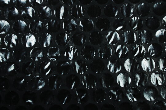 Black Bubble Wrap Plastic Texture Close Up With Circular Air Pocket Pattern Background
