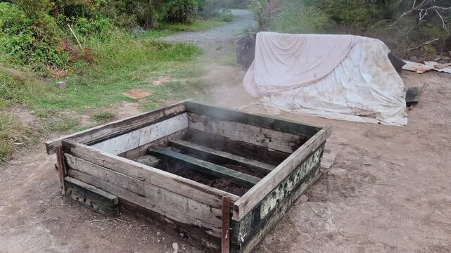 A steaming traditional Māori Hāngī earth oven used for cooking with geothermal steam in Tokaanu, New Zealand.
