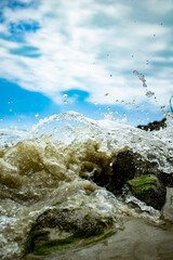 Splashing water wave against rocks in river stream