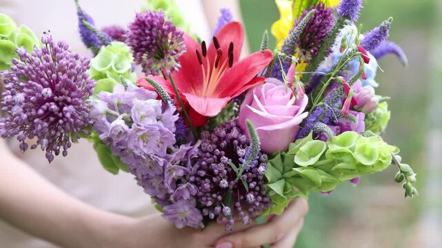 Woman with bouquet of beautiful summer flowers outdoors, closeup