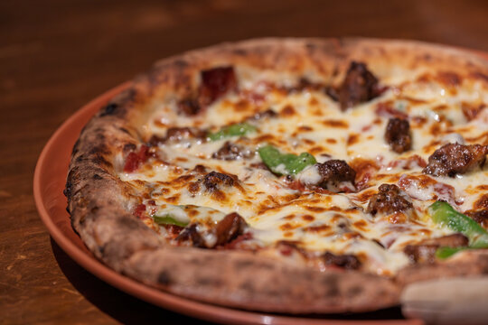 Delicious cheesy meat bell pepper Italian pizza on baking tray