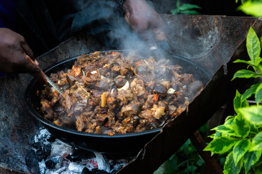 Ogun, Nigeria &ndash; July 4, 2026. A man prepares asun, a spicy Nigerian dish made from seasoned roasted goat meat, at an outdoor event in Ogun State, Nigeria