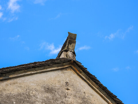 Historic Architecture Detail with Old Clay Roof Tiles and Soft Clouds