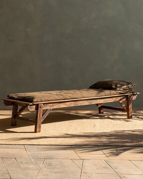 folding timber cot woodland camping furniture set against a warm plaster wall
