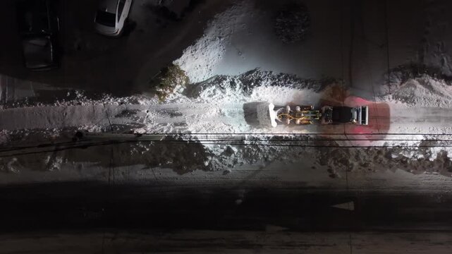 In the aftermath of the Halifax snowstorm, a snow plow operates during the night to clear the streets of Beachville