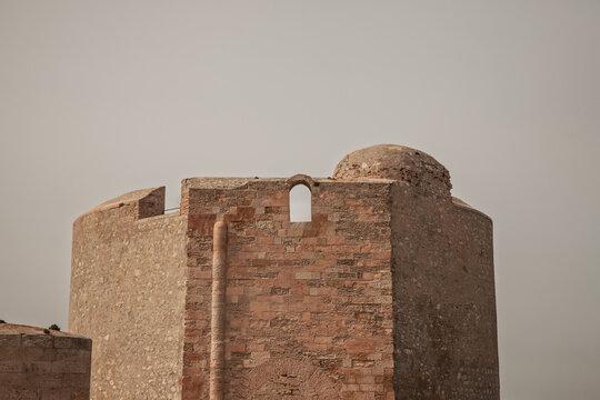 Close view of a stone tower and fortification at Chateau d'If, in Marseille, France, the historic island fortress in the Frioul archipelago, showing weathered masonry and defensive architecture.