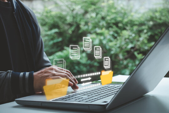 Businessman using laptop with digital file transfer interface, document sharing, folder management, data synchronization, cloud storage, online collaboration, remote work, business modern technology.