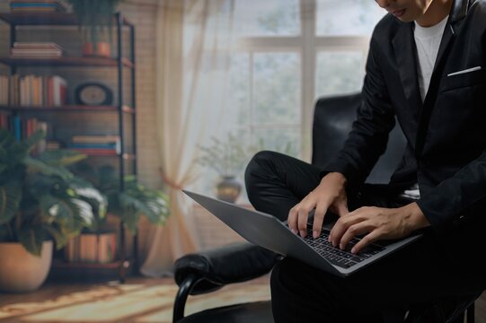 Person Working on Laptop in Stylish Modern Workspace Interior