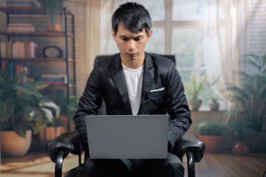 Professional Man Working on Laptop in Modern Office Environment