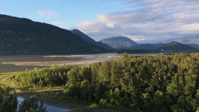 Majestic River Landscape in British Columbia, Canada with Mountains and Green Forests