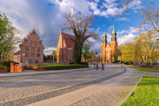 Poznan Cathedral and historic brick buildings along a cobblestone street on Ostrow Tumski in Poznan, Poland.