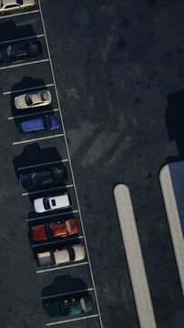 In a parking lot, several cars are parked in marked spaces. Some parking spots are empty. The scene shows a variety of colored vehicles in organized rows.