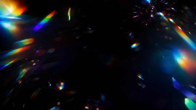 Abstract rainbow light refraction on black background with colorful prism flares, holographic crystal reflections, spectrum glow, lens distortion and iridescent light leak texture