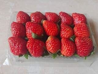 closeup texture of strawberries in a plastic pack © DNA