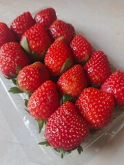 strawberries in a plastic pack, red and fresh © DNA
