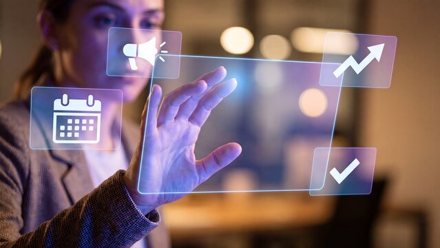 Marketing campaign scheduling platform, businesswoman tapping holographic interface with megaphone, calendar, growth chart and approval icons for promotion planning and performance management