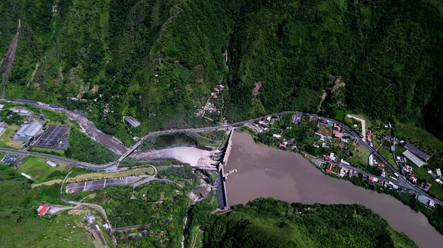 Wide Aerial View of Rugged Ecuador Mountain Valley with Dense Forest, River Town, Dramatic Clouds and Scenic Andean Amazon Travel Landscape