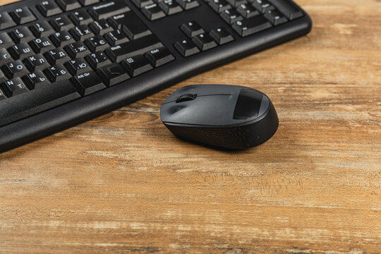 Office workspace with computer keyboard and mouse on wooden desk