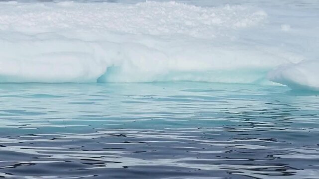 Floating iceberg in Arctic ocean water, melting ice block in polar sea, climate change concept