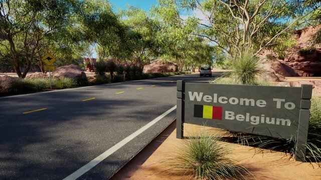Welcome to Belgium road sign on sunny highway, asphalt road through green trees and red rocks, belgian border crossing concept