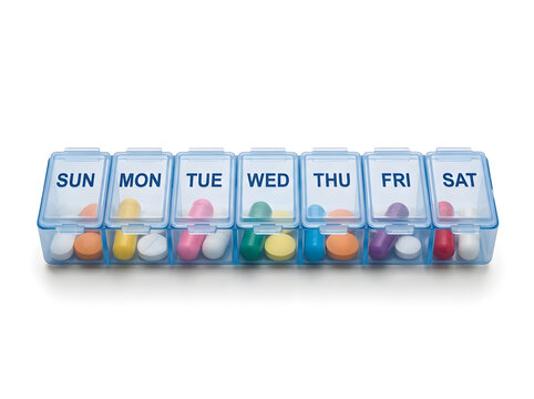 Weekly pill organizer with colorful medication compartments isolated on white background
