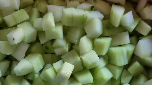 Top view close up of fresh diced cucumber and diced carrots prepared as food ingredients