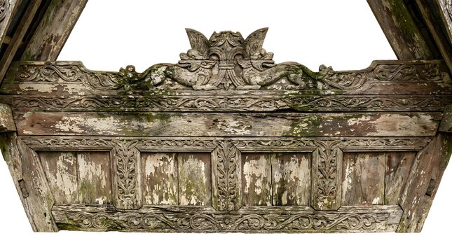 Ornate weathered wood carvings on a traditional Batak house roof, showcasing Indonesian heritage craftsmanship