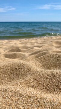 Golden sand dunes meeting ocean waves on beach