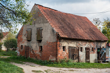 Old brick house with weathered facade in Gvardeysk, Russia © Elena Odareeva