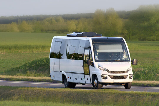 Road travel bus crossing a lush green area