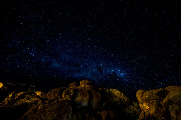Milky Way and Starry Night over Boulders in Desert © tony