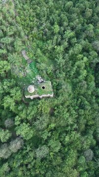 Vertical Drone View of Arakelots Monastery Hidden in Dense Forest.