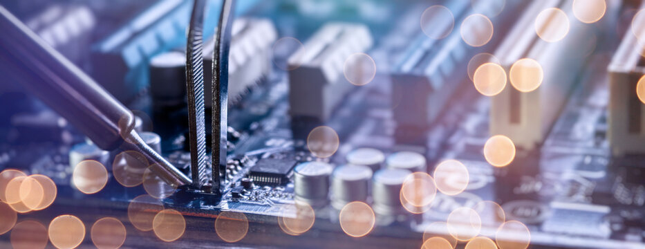 Abstract electronic engineering background. IT hardware repair concept with circuit board components and blurred light effects.