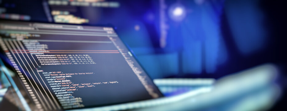 Programming code on laptop screen showing data analytics and software development process with copy space.