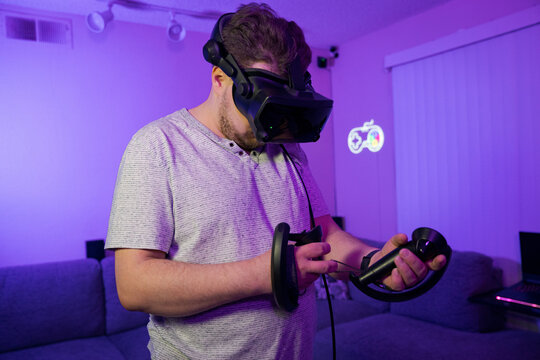 Man using VR controllers in virtual reality environment