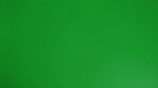 A dark, amorphous blob sits on a vibrant green background.