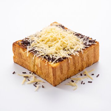 Thick slice toasted bread topped with shredded cheddar cheese and chocolate sprinkles Roti Bakar