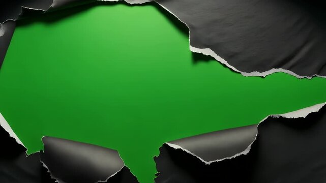 A torn black paper revealing a vibrant green background.