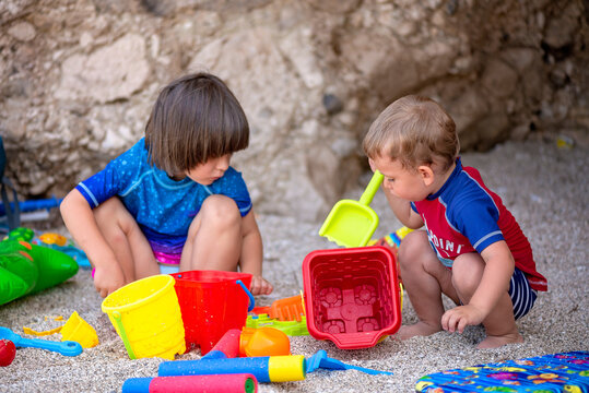 Children Playing with Beach Toys in the Sand