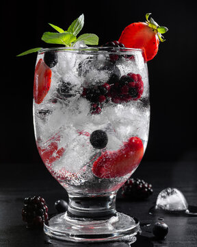 Close Up of Sparkling Fruit Drink With Ice Berries Strawberries and Mint