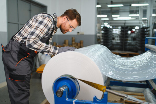 Worker supervising polyethylene plastic film production