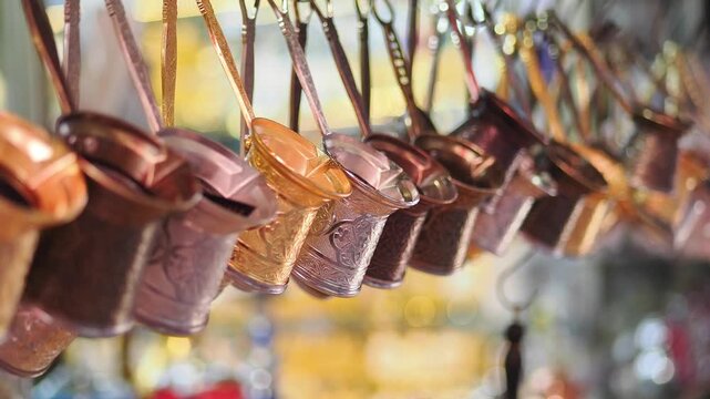 Row of Traditional Copper Turkish Coffee Pots Hanging in a Market
