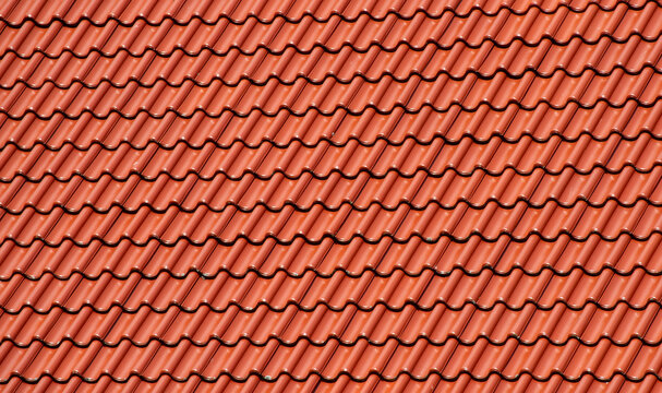 Red ceramic roof tiles texture background with repeating wave pattern architecture detail