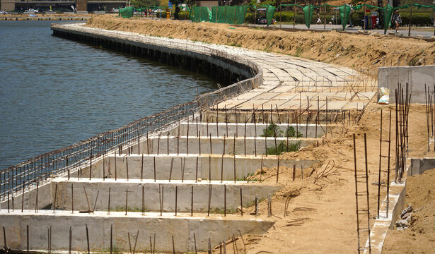 Building process city levee. Exposed foundation rebar grid at site, standing formwork and concrete footings