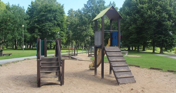 Empty Wooden Playground Tower Slide Structure in Summer Public Park

