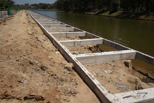 Building process city levee. Exposed foundation rebar grid at site, standing formwork and concrete footings