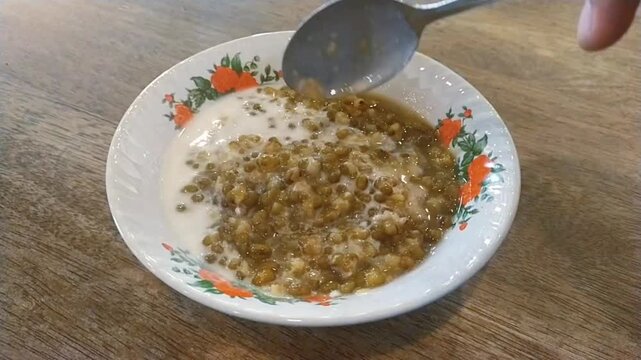 A bowl of Bubur Kacang Hijau (green bean porridge), a sweet Indonesian porridge made from green beans, coconut milk, and palm or cane sugar