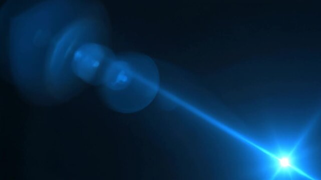 Bright blue glowing light burst with lens flare effect on dark background for space or technology themes
