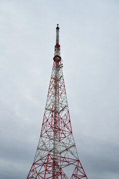 Telecommunications tower, a masthead television antenna against a cloudy sky.